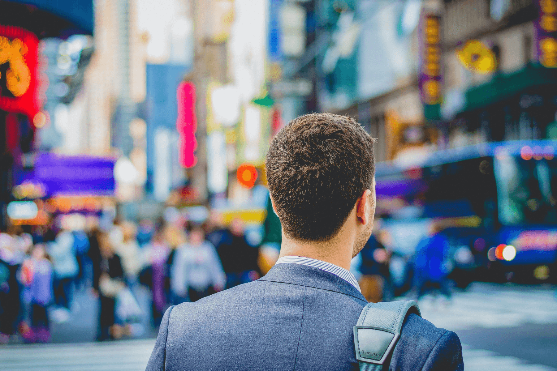 Future proof your career: jobs with high growth potential. Photo behind man in suit standing in busy city.