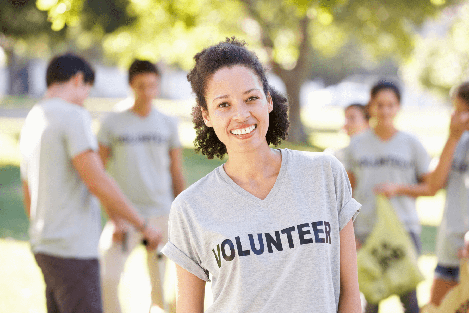 Woman standing in front of group wearing volunteer shirt